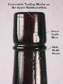 Close-up picture of the side seam on a tooled finish on an early 20th century liquor bottle.